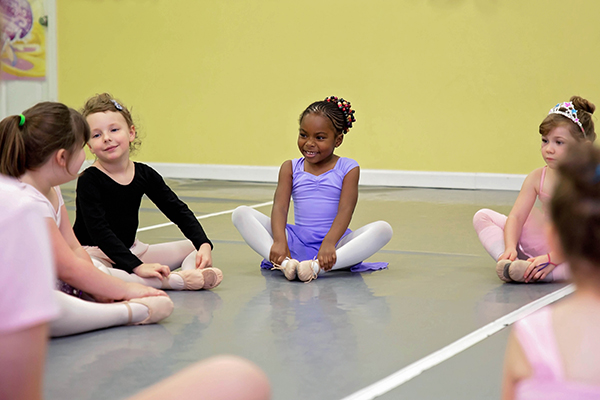 Little girls stretching during ballet dance lessons at Starr Studios Salem School of Dance